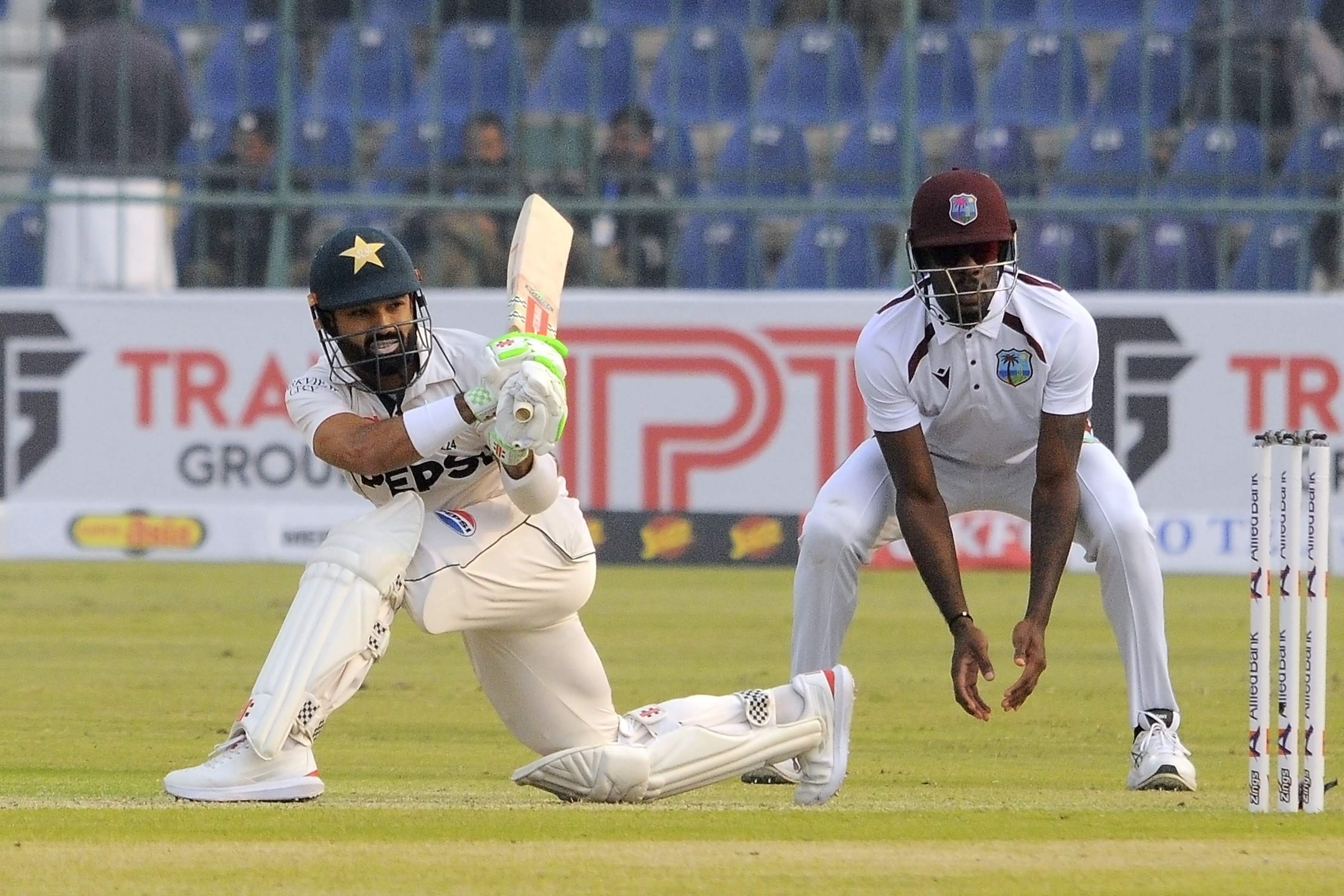 Pakistan's Mohammad Rizwan, left, plays a shot during the day one of the first test cricket match between Pakistan and West Indies, in Multan, Pakistan, Friday, Jan. 17, 2025. 