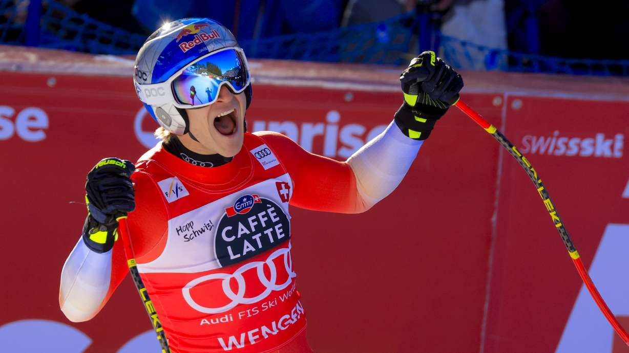 Switzerland's Marco Odermatt celebrates at the finish area of an alpine ski, men's World Cup downhill, in Wengen, Switzerland, Saturday, Jan. 18, 2025