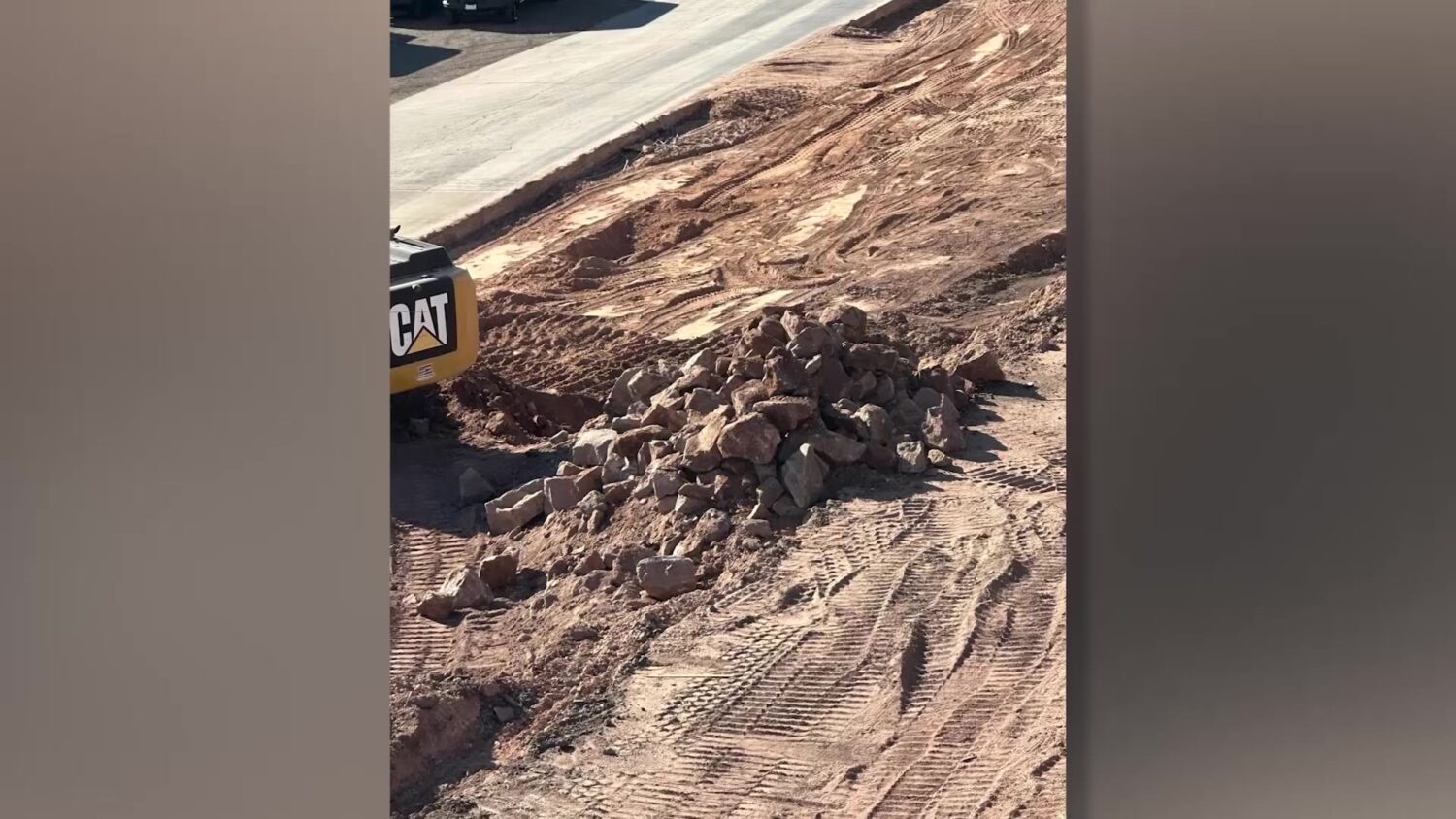 Construction equipment next to a pile of rocks that have petroglyphs on them in St. George.