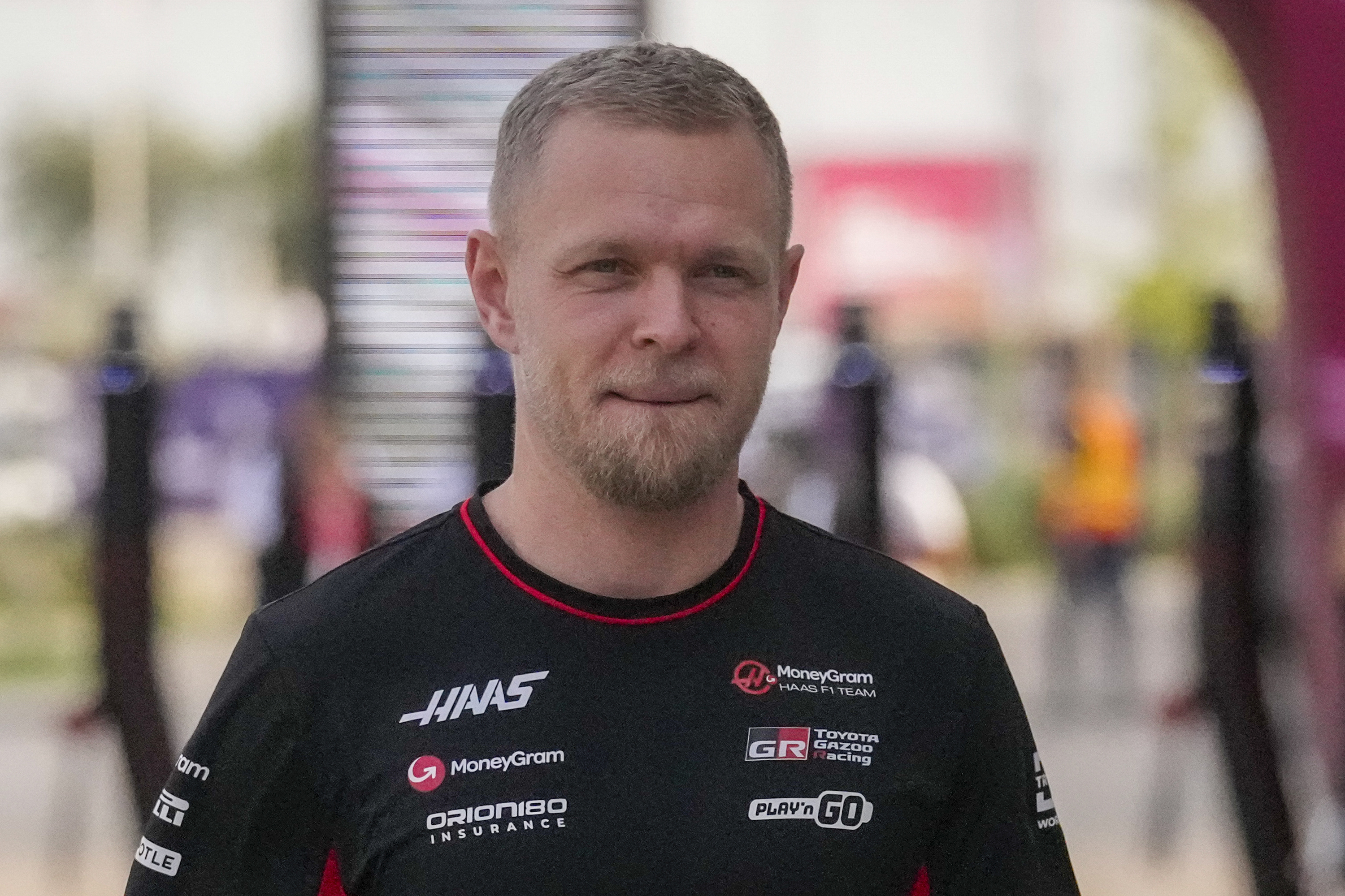 FILE - Haas driver Kevin Magnussen of Denmark walks through paddock as he arrives at the Lusail International Circuit in Lusail, Qatar, ahead of the Qatar Grand Prix, Thursday, Nov. 28, 2024.
