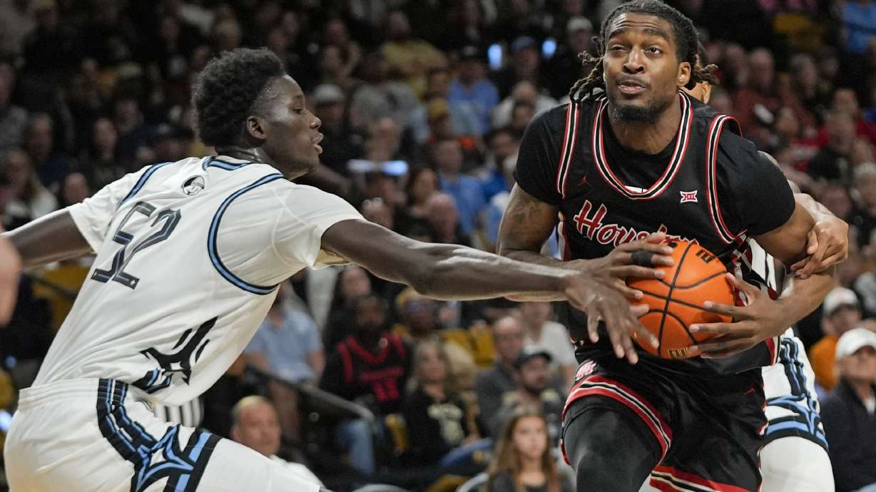 Houston forward Ja'Vier Francis, right, goes to the basket as Central Florida center Moustapha Thiam (52) defends during the first half of an NCAA college basketball game, Saturday, Jan. 18, 2025, in Orlando, Fla.