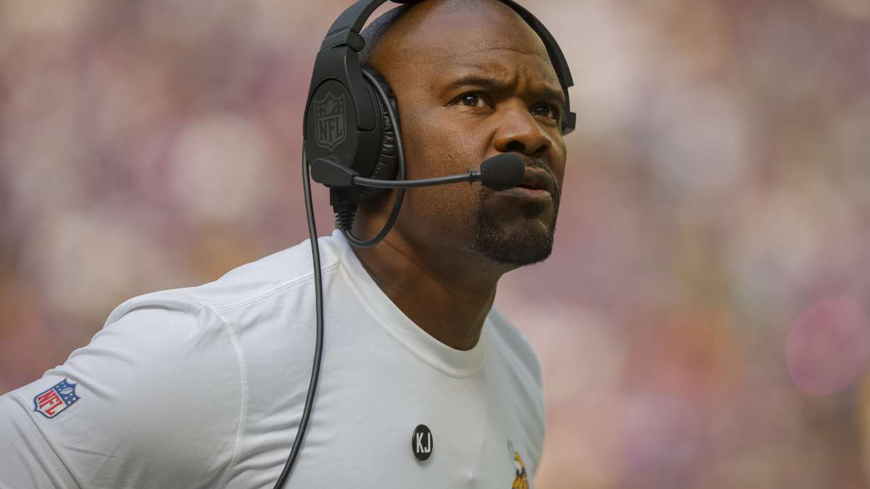 FILE - Minnesota Vikings Defensive coordinator Brian Flores looks to the scoreboard in the first half of an NFL football game against the Houston Texans, Sunday, Sept. 22, 2024, in Minneapolis.