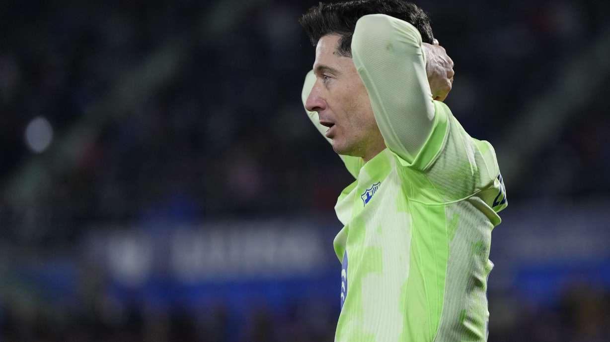Barcelona's Robert Lewandowski reacts after missing a chance to score against Getafe during a Spanish La Liga soccer match at the Coliseum Alfonso Perez stadium in Getafe, Spain, Saturday, Jan. 18, 2025.