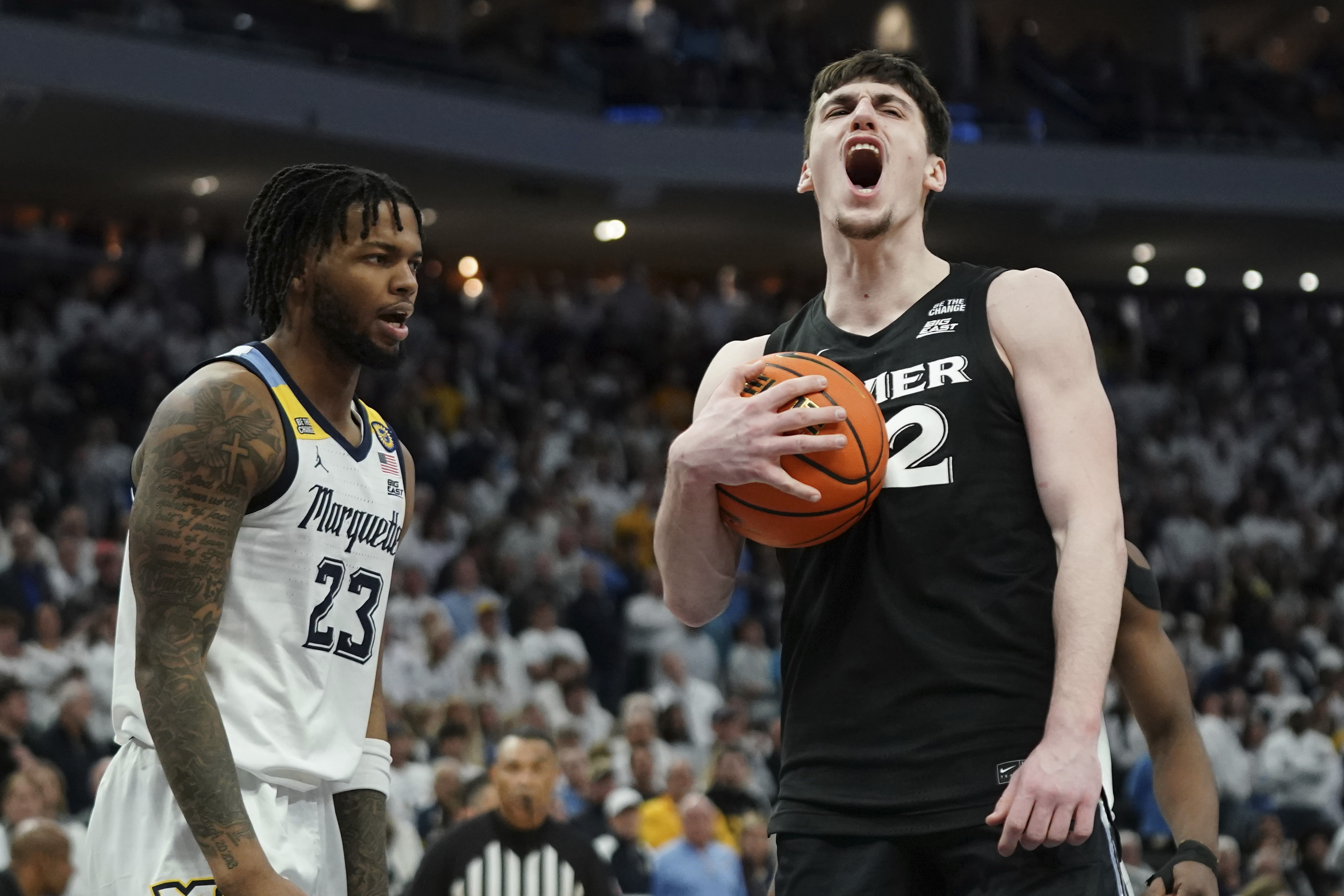 Xavier's Zach Freemantle, right, reacts in front of Marquette's David Joplin (23) during the second half of an NCAA college basketball game Saturday, Jan. 18, 2025, in Milwaukee.