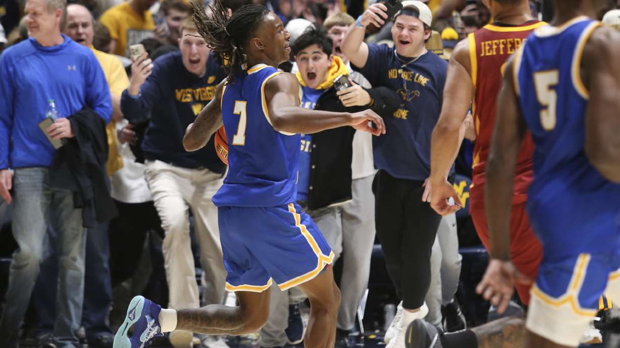 West Virginia guard Javon Small (7) celebrates with the students after defeating Iowa State in a NCAA college basketball game, Saturday, Jan. 18, 2025, in Morgantown, W.Va.