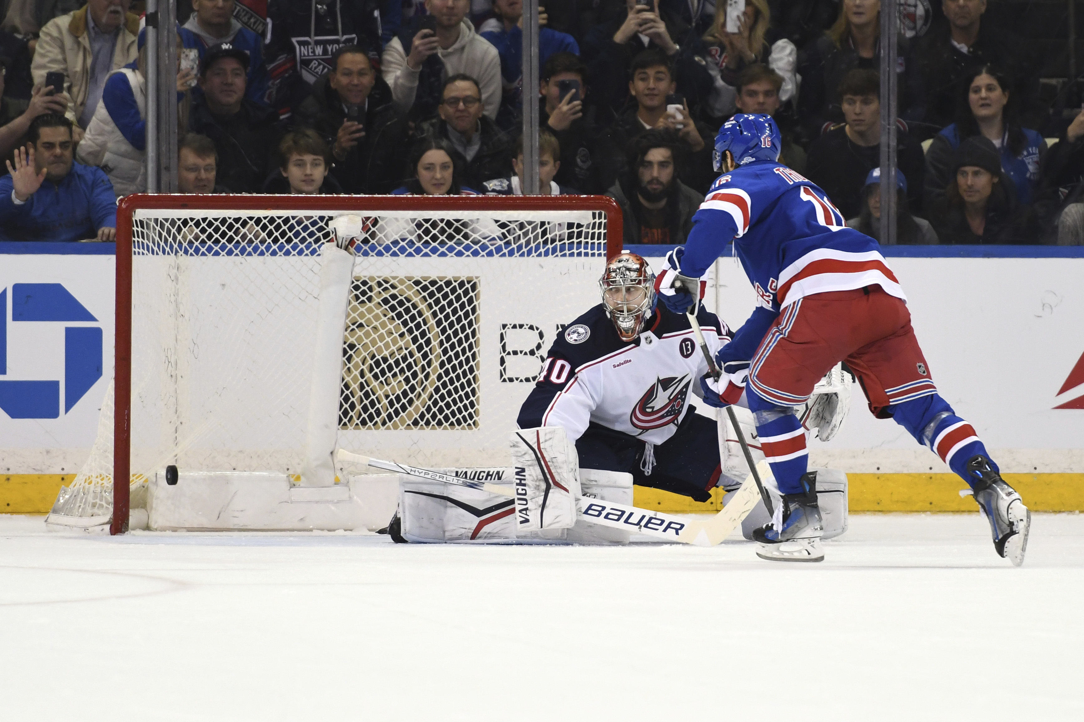 New York Rangers' Vincent Trocheck, right, scores a goal past Columbus Blue Jackets' Daniil Tarasov, left, during a shootout during overtime of an NHL hockey game Saturday, Jan. 18, 2025, in New York. 