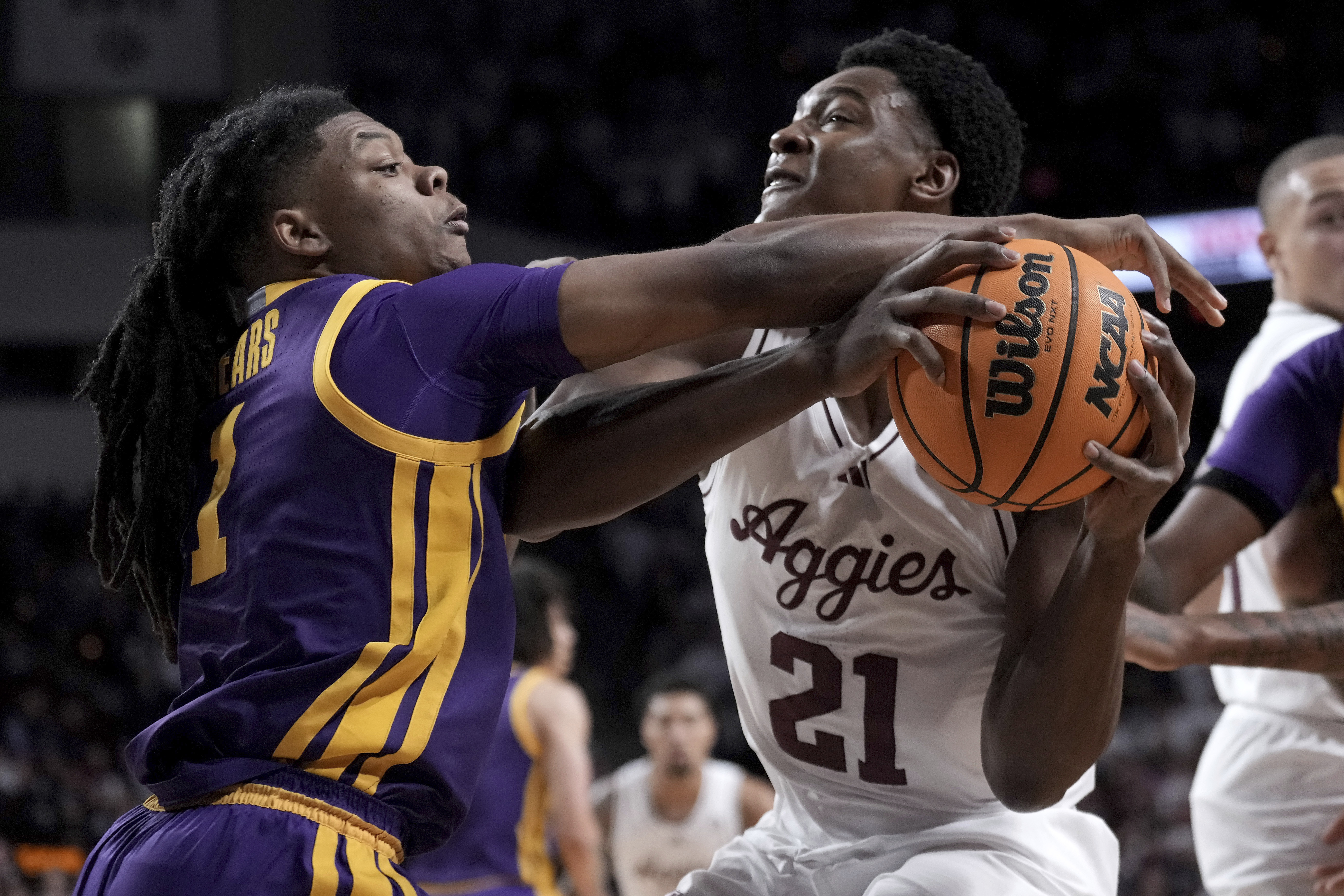 Texas A&M forward Pharrel Payne (21) is fouled by LSU guard Jordan Sears (1) during the first half of an NCAA college basketball game Saturday, Jan. 18, 2025, in College Station, Texas.