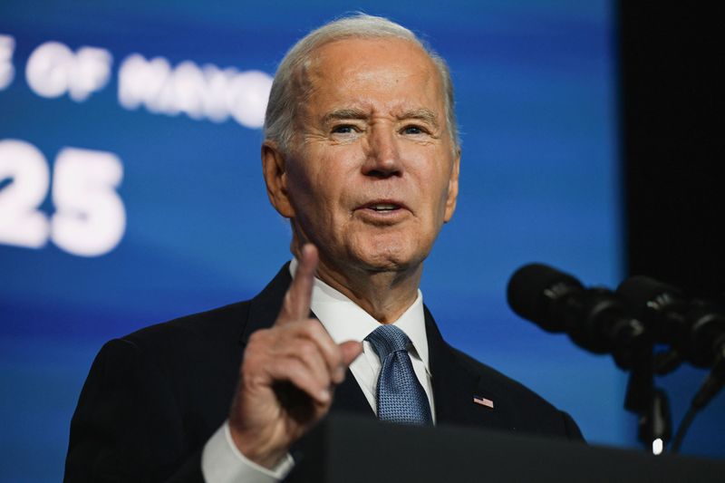 President Joe Biden delivers remarks at the U.S. Conference of Mayors in Washington, Friday. Biden pardoned five people on Sunday, including the late civil rights leader Marcus Garvey, and commuted the sentences of two, the White House said.