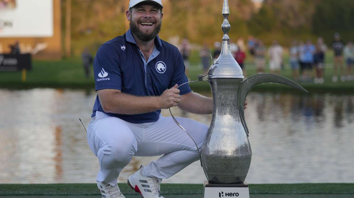 Tyrell Hatton of England poses with the trophy after winning the Dubai Desert Classic golf tournament, in Dubai, United Arab Emirates, Sunday, Jan. 19, 2025.