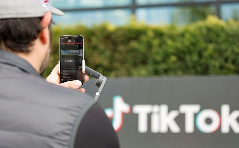 TikToker and "newsfluencer" Joe Andaloro, who goes by the TikTok handle @joy.of.everything, films a TikTok video outside the U.S. headquarters of the social media company TikTok in Culver City, California, Saturday. 