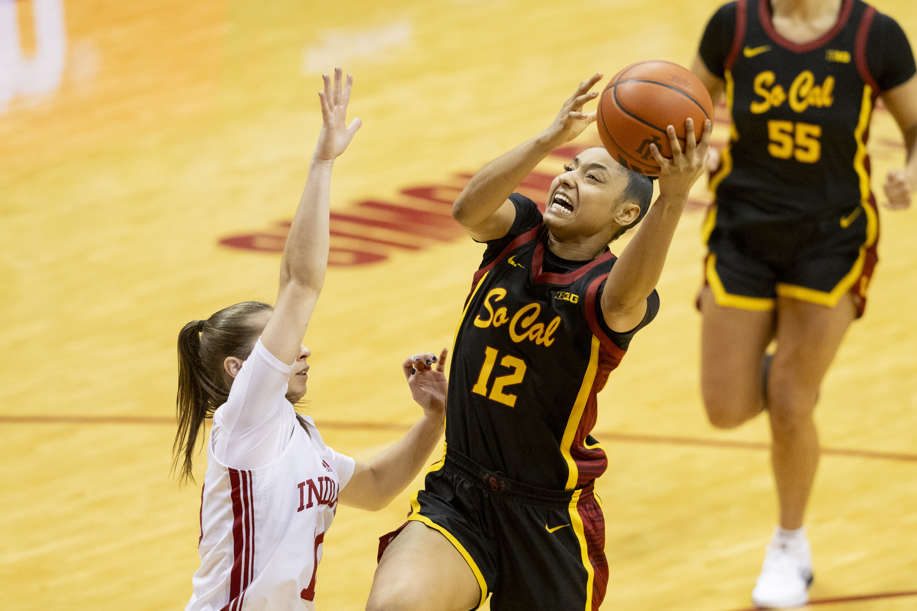 USC guard JuJu Watkins (12) shoots while being defended by Indiana guard Lexus Bargesser, left, during the second half of an NCAA college basketball game, Sunday, Jan. 19, 2025, in Bloomington, Ind. 