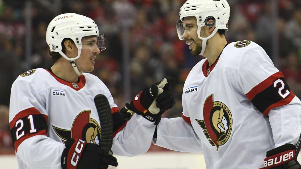 Ottawa Senators' Nick Cousins, left, and Artem Zub, right, react after Zub scored a goal during the third period of an NHL hockey game against the New Jersey Devils Sunday, Jan. 19, 2025, in Newark, N.J.