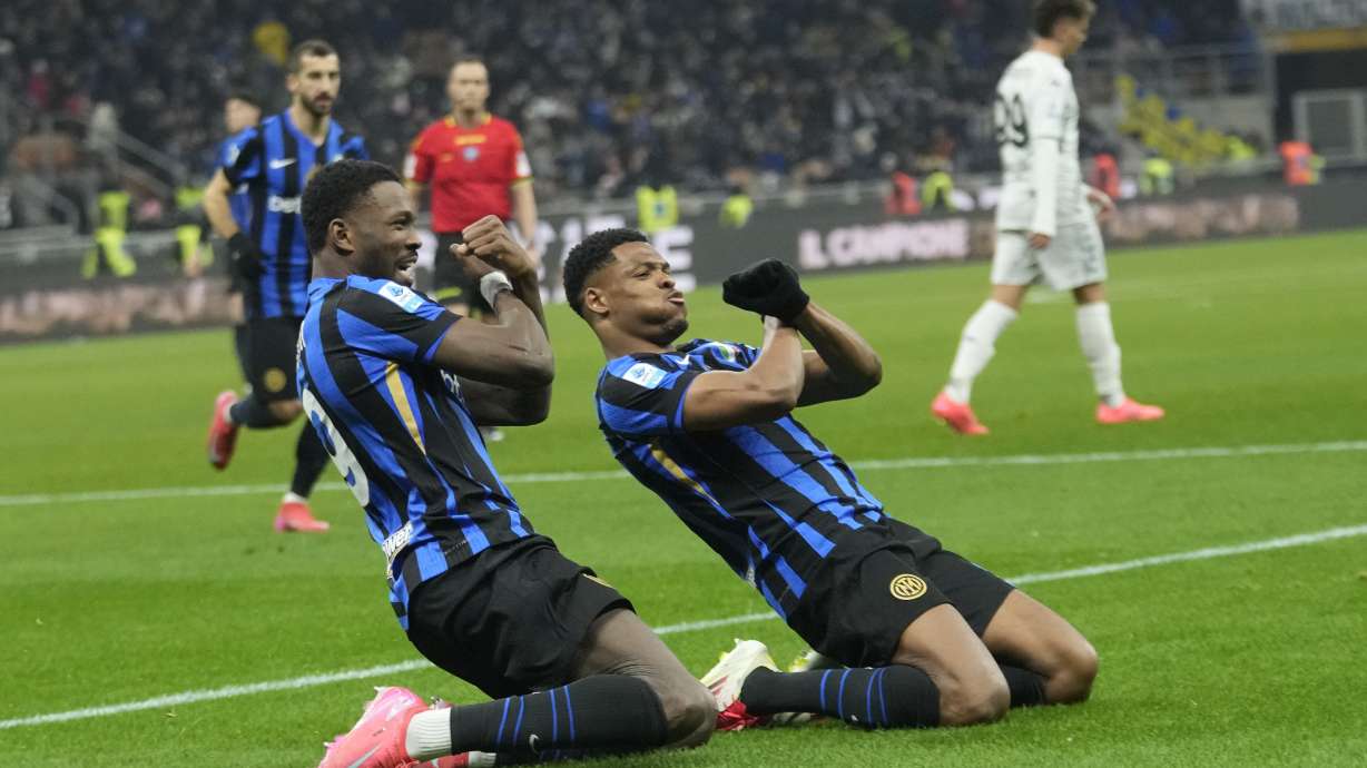 Inter Milan's Denzel Dumfries, right, celebrates after scoring his side's second goal with Marcus Thuram during the Serie A soccer match between Inter Milan and Empoli at the San Siro stadium in Milan, Italy, Sunday, Jan. 19, 2025.