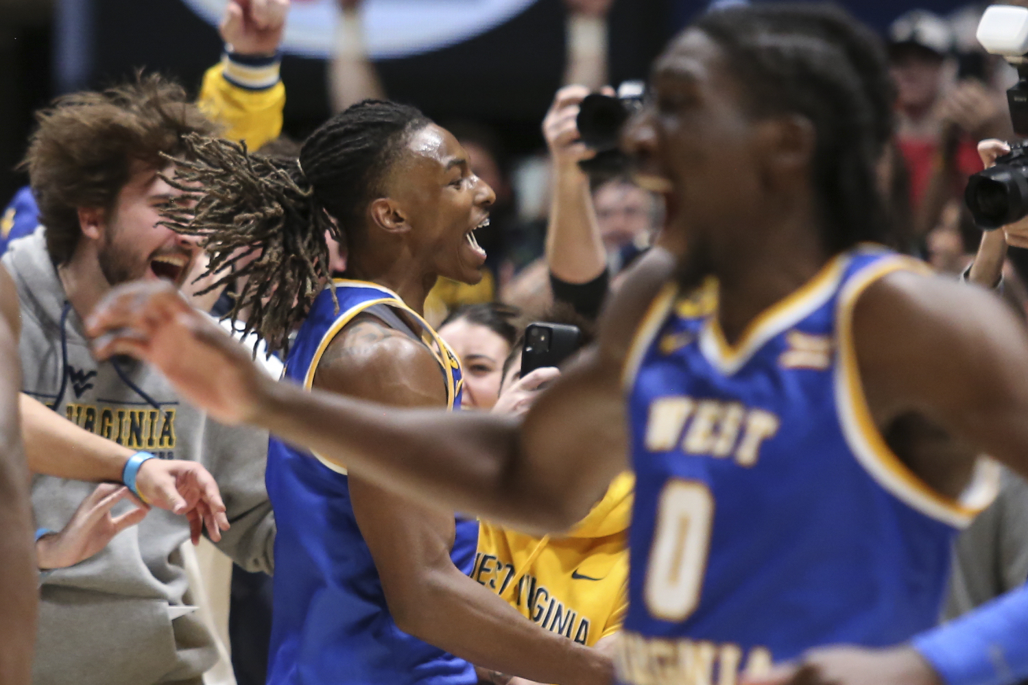 West Virginia guard Javon Small (7) celebrates with the students after defeating Iowa State in a NCAA college basketball game, Saturday, Jan. 18, 2025, in Morgantown, W.Va.