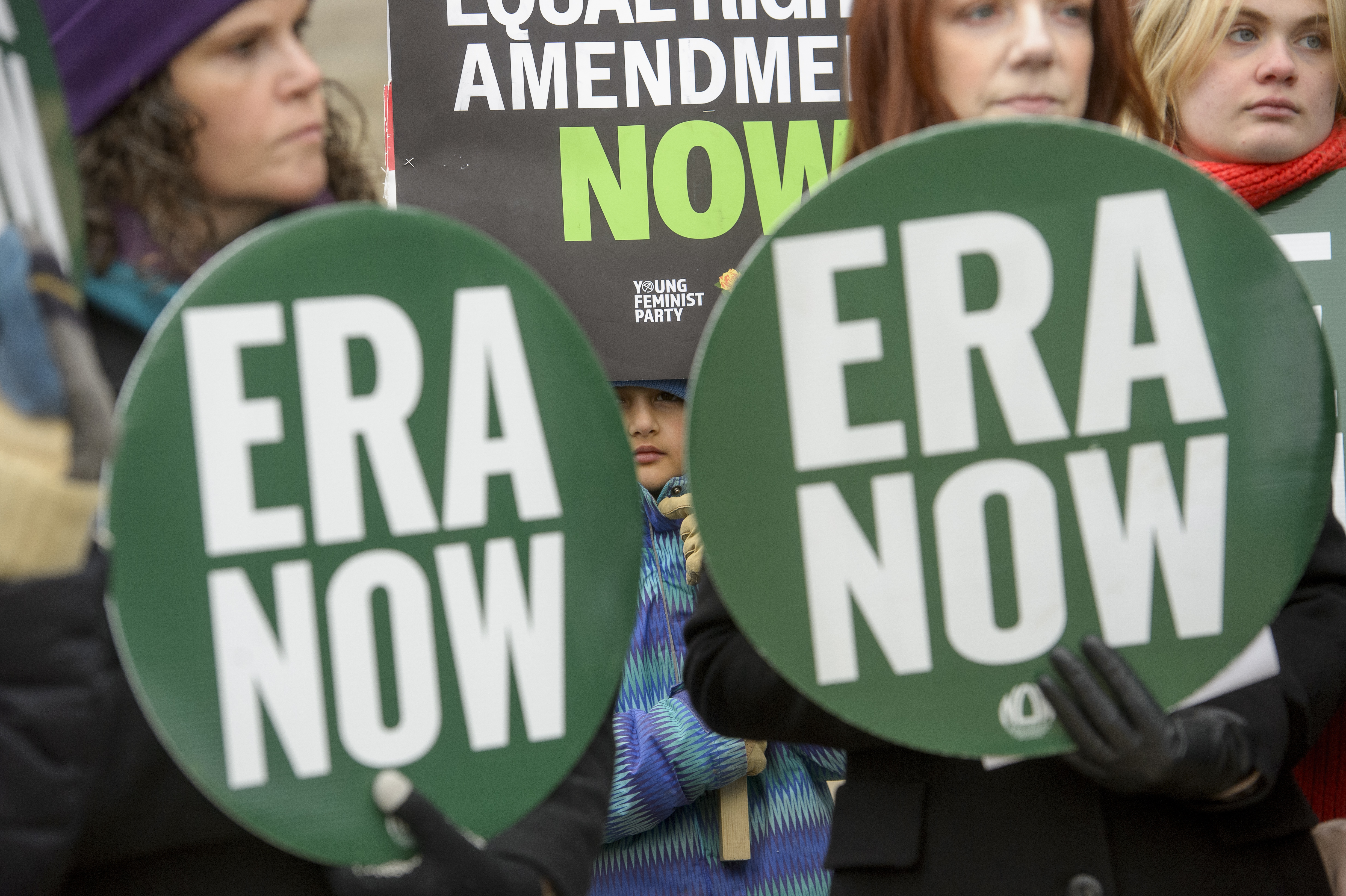 People hold a rally in front of the National Archives to highlight President Joe Biden's decision to declare the Equal Rights Amendment as the 28th Amendment to the United States Constitution, Friday in Washington.