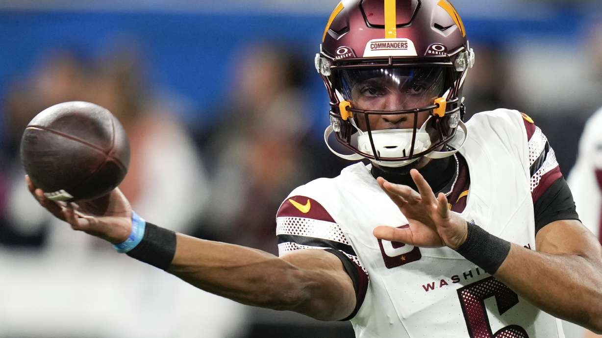 Washington Commanders quarterback Jayden Daniels throws during warmups before an NFL football divisional playoff game, Saturday, Jan. 18, 2025, in Detroit.