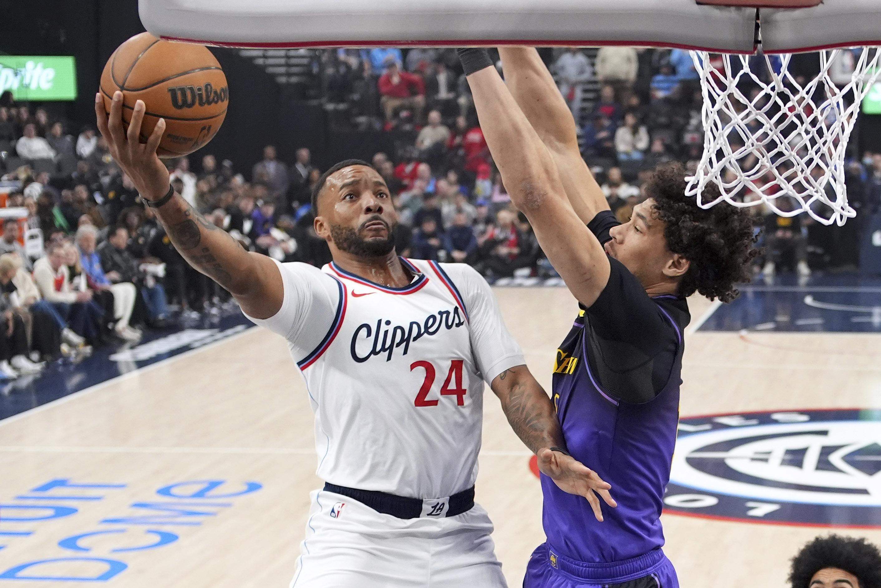 Los Angeles Clippers guard Norman Powell, left, shoots as Los Angeles Lakers center Jaxson Hayes defends during the first half of an NBA basketball game, Sunday, Jan. 19, 2025, in Inglewood, Calif. 