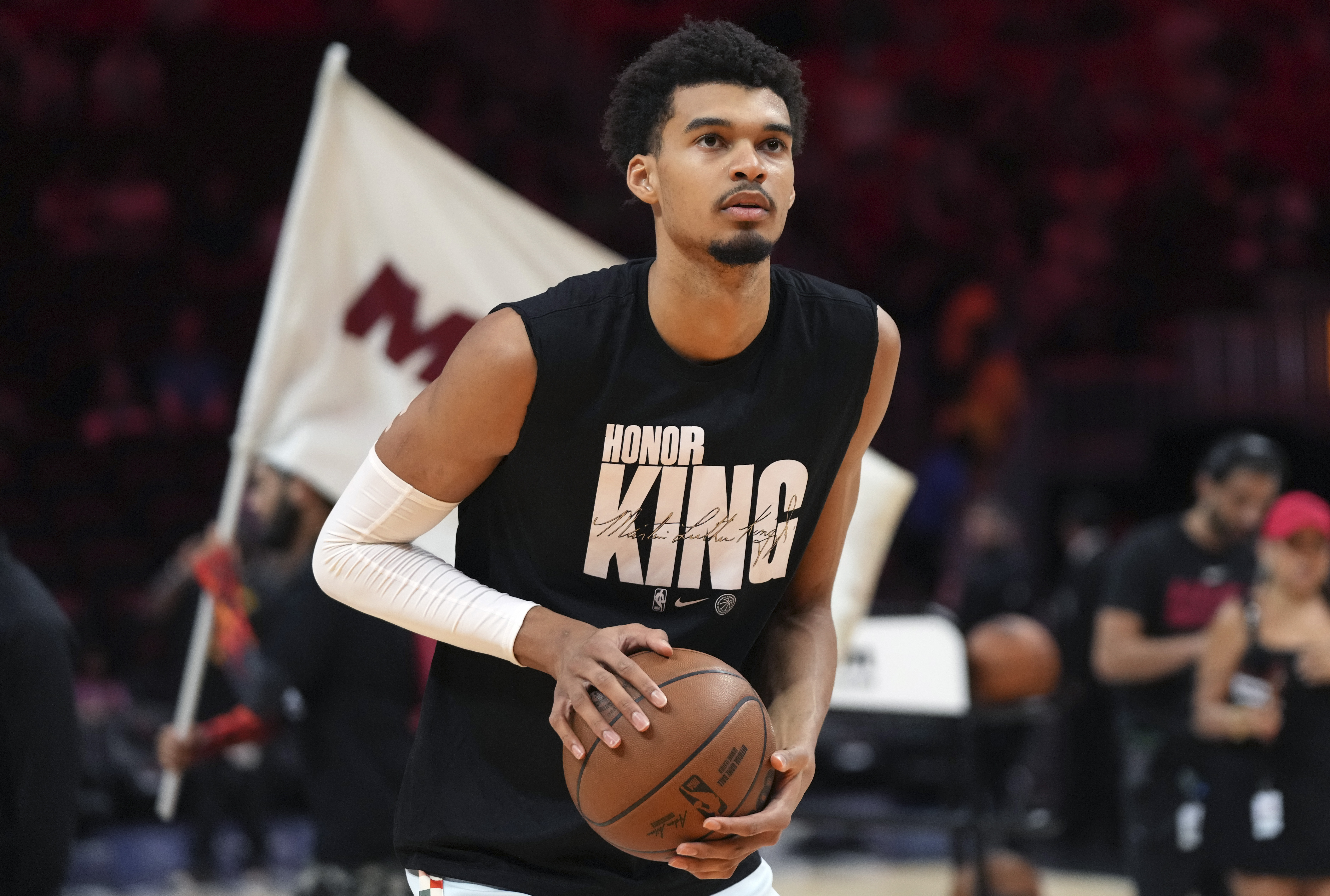San Antonio Spurs center Victor Wembanyama wears a t-shirt in honor of Martin Luther King Jr. as he warms up before an NBA basketball game against the Miami Heat, Sunday, Jan. 19, 2025, in Miami.