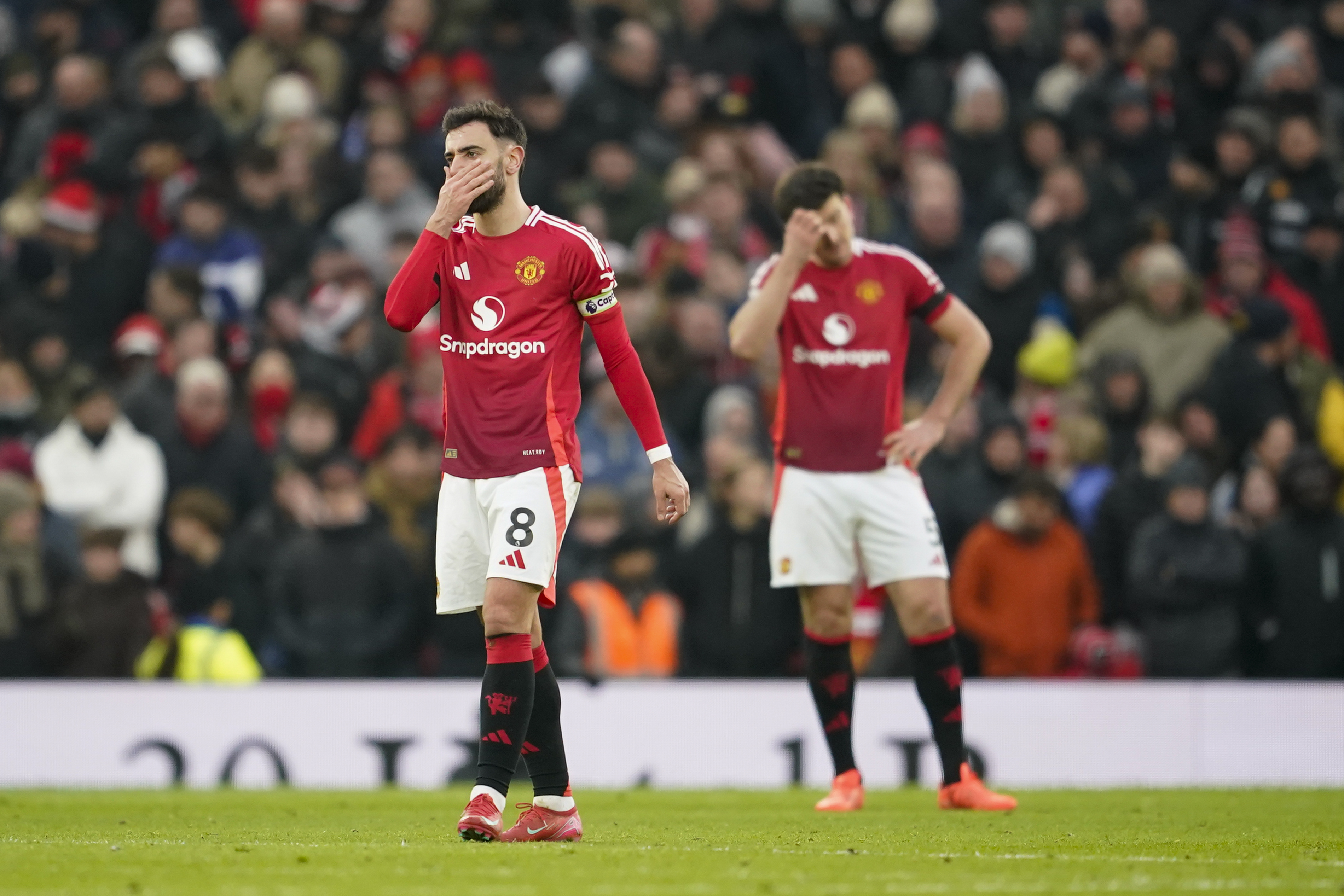 Manchester United's Bruno Fernandes, left, and Harry Maguire react after Brighton scored its side third goal during the English Premier League soccer match between Manchester United and Brighton and Hove Albion, at the Old Trafford stadium in Manchester, England, Sunday, Jan. 19, 2025.