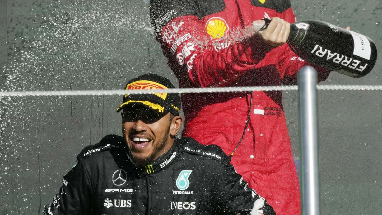 FILE - Second placed Mercedes driver Lewis Hamilton of Britain, bottom, is sprayed with champagne by third placed Ferrari driver Charles Leclerc of Monaco on the podium for the Formula One Mexico Grand Prix auto race at the Hermanos Rodriguez racetrack in Mexico City, Sunday, Oct. 29, 2023.