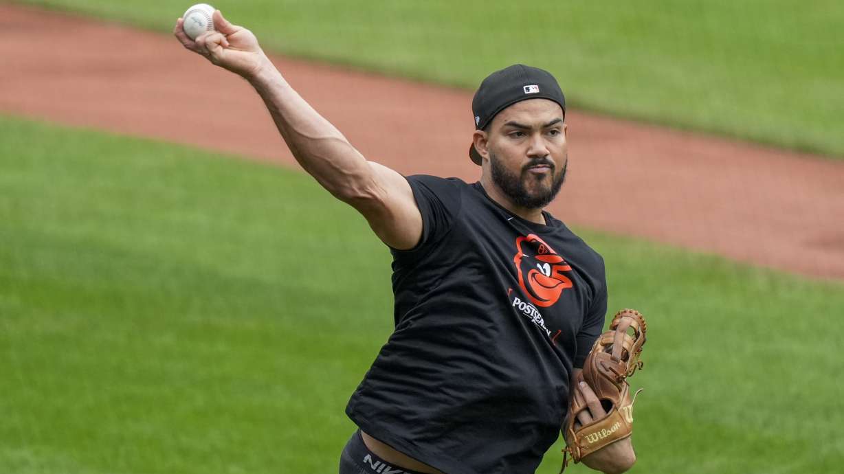 FILE - Baltimore Orioles right fielder Anthony Santander warms up during a baseball workout a day before the team's wild card playoff game against the Kansas City Royals, Monday, Sept. 30, 2024, in Baltimore.