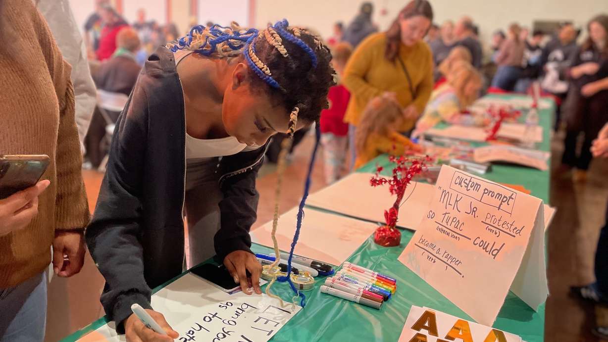 Anita Curtis makes a sign ahead of a planned march at a rally Monday, Jan. 20, 2025, in Ogden to mark Martin Luther King Jr. Day.