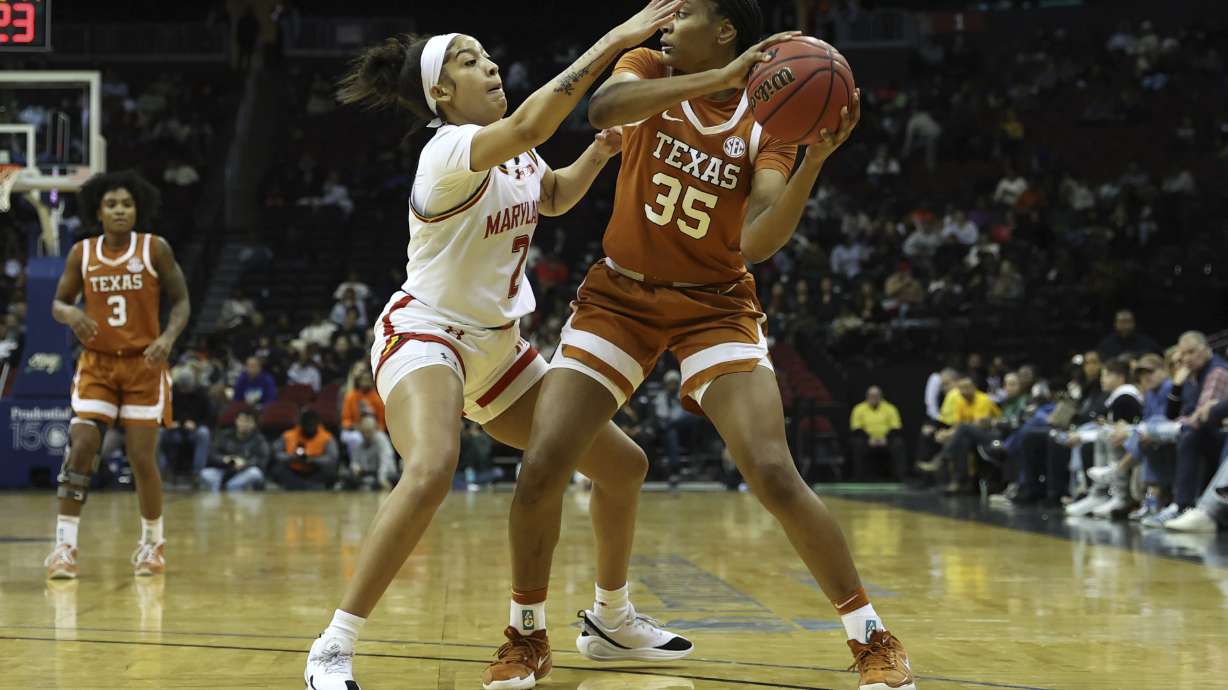 Texas forward Madison Booker, right, looks to pass the ball past Maryland guard Kaylene Smikle, left, during the first half of an NCAA college basketball game, Monday, Jan. 20, 2025, in Newark, N.J.