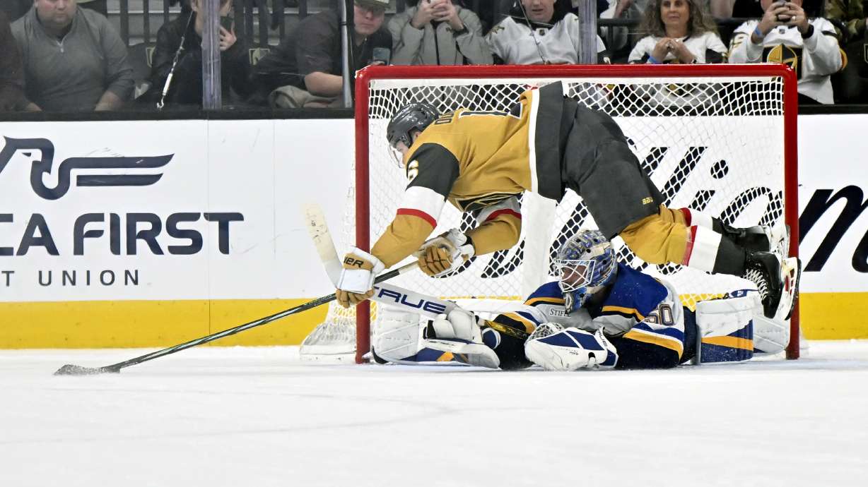 Vegas Golden Knights left wing Pavel Dorofeyev, top, attempts to score during a shootout against St. Louis Blues goaltender Jordan Binnington, bottom, in an NHL hockey game Monday, Jan. 20, 2025, in Las Vegas.
