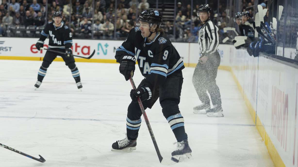 Utah Hockey Club center Clayton Keller (9) moves the puck against the Winnipeg Jets during the first period of an NHL hockey game Monday, Jan. 20, 2025, in Salt Lake City.