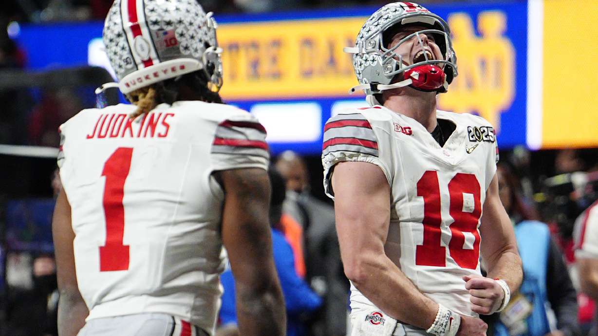 Ohio State quarterback Will Howard celebrates after a touchdown by running back Quinshon Judkins during second half of the College Football Playoff national championship game against Notre Dame Monday, Jan. 20, 2025, in Atlanta.