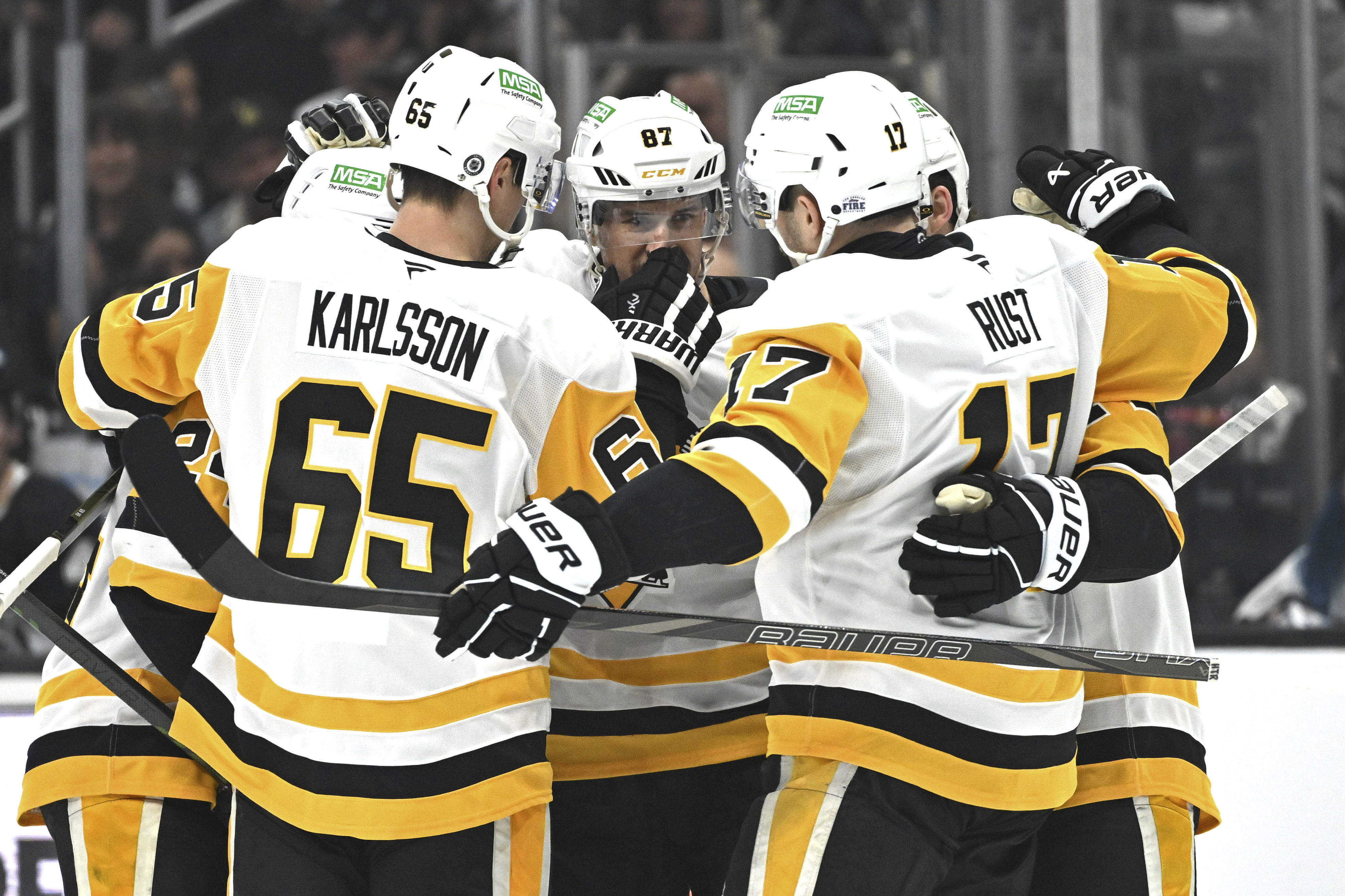 Pittsburgh Penguins center Sidney Crosby (87) is congratulated by teammates after scoring during the first period of an NHL hockey game against the Los Angeles Kings, Monday, Jan. 20, 2025, in Los Angeles. 