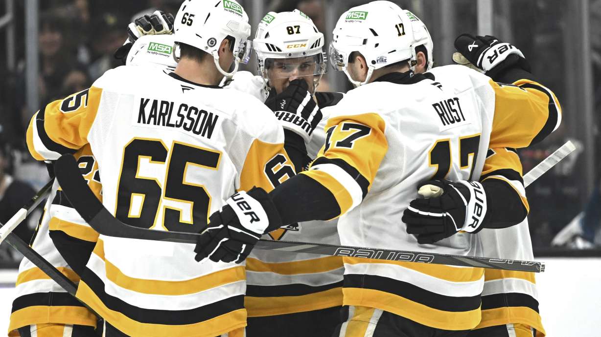 Pittsburgh Penguins center Sidney Crosby (87) is congratulated by teammates after scoring during the first period of an NHL hockey game against the Los Angeles Kings, Monday, Jan. 20, 2025, in Los Angeles.
