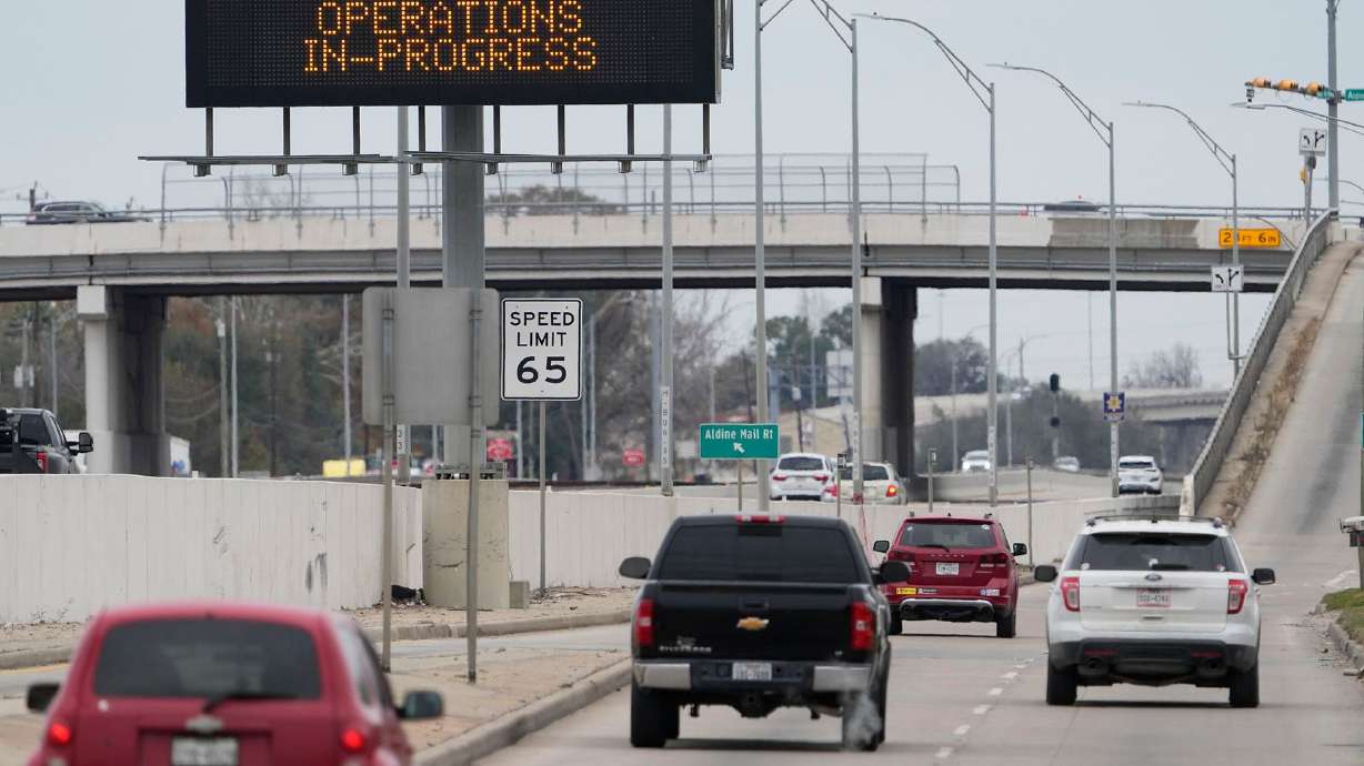 Vehicles pass a sign displaying Winter storm related operations Monday in Houston ahead of predicted several inches of snow and possibly ice in Southeast Texas.
