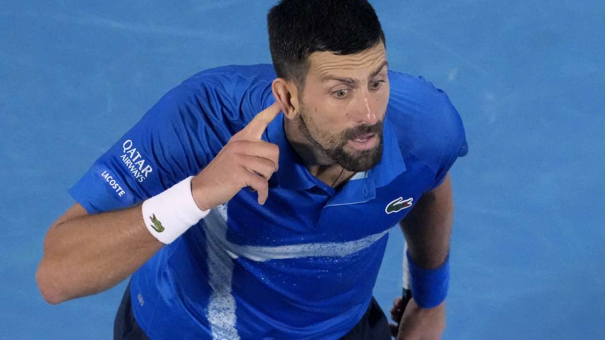 Novak Djokovic of Serbia gestures during his quarterfinal match against Carlos Alcaraz of Spain at the Australian Open tennis championship in Melbourne, Australia, Tuesday, Jan. 21, 2025.