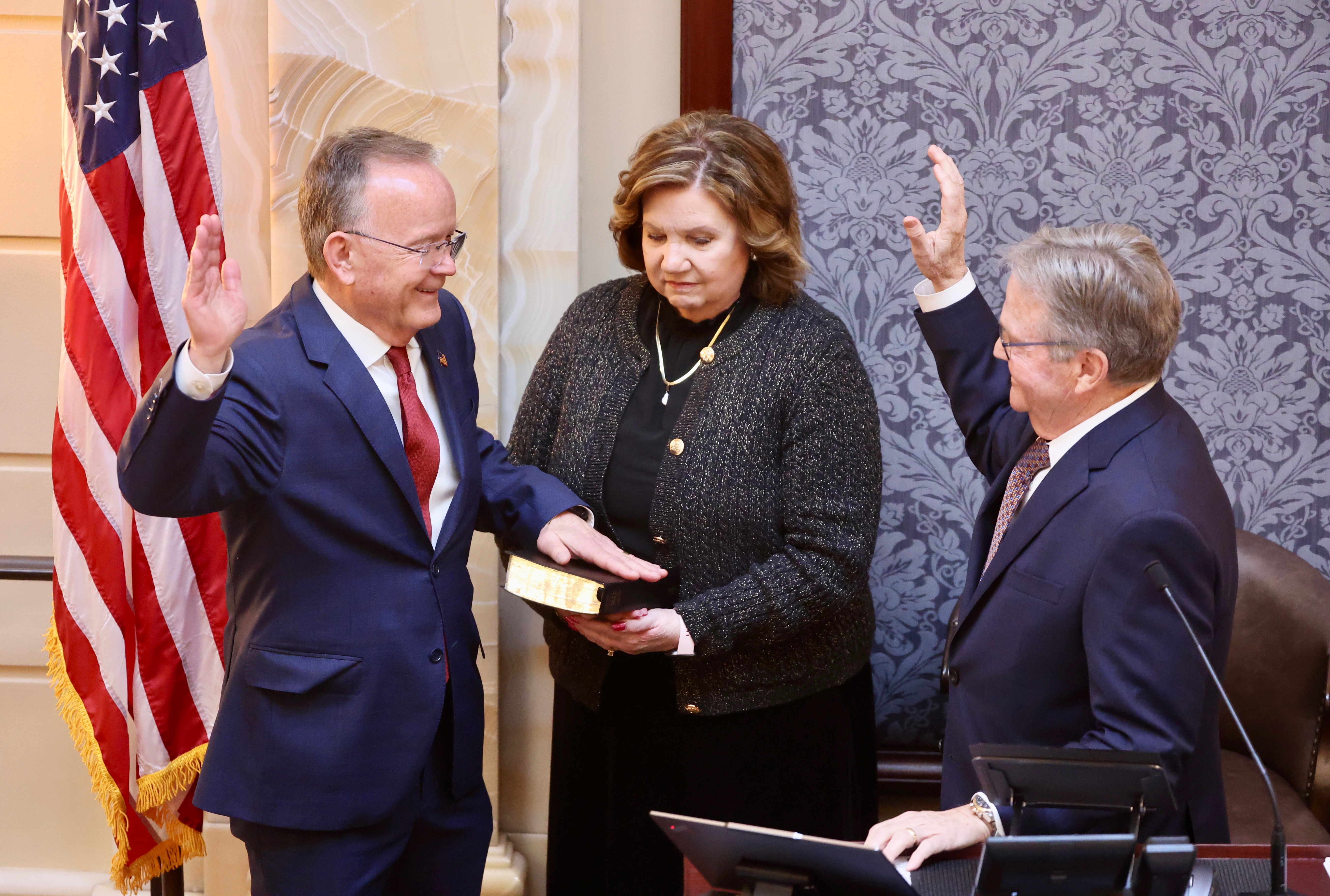 Senate President Stuart Adams is sworn in by Senate Budget Chairman Jerry Stevenson, R-Layton, with Adams’ wife Susan looking on, as part of their opening session on the first day of the Legislature held at the state Capitol in Salt Lake City on Tuesday.