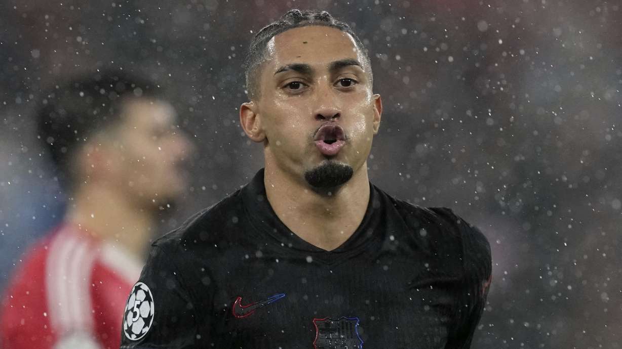 Barcelona's Raphinha celebrates his side's fifth goal during a Champions League opening phase soccer match between SL Benfica and FC Barcelona at the Luz stadium in Lisbon, Tuesday, Jan. 21, 2025.