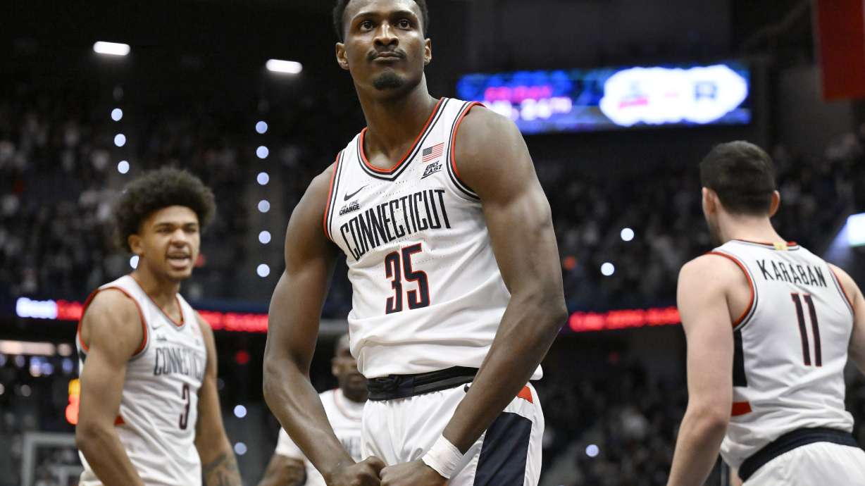 UConn center Samson Johnson (35) flexes after making a basket in the first half of an NCAA college basketball game against Butler, Tuesday, Jan. 21, 2025, in Hartford, Conn.