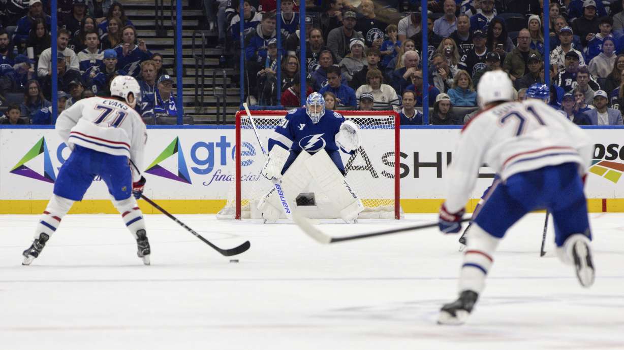 Tampa Bay Lightning goaltender Jonas Johansson (31) defends the goal as Montreal Canadiens center Jake Evans (71) advances to score during the second period of an NHL hockey game, Sunday, Dec. 29, 2024, in Tampa, Fla.