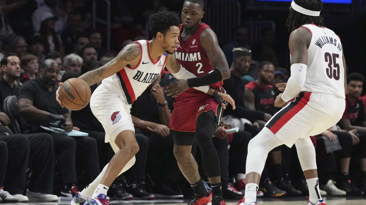 Miami Heat guard Terry Rozier (2) defends against Portland Trail Blazers guard Anfernee Simons during the first half of an NBA basketball game, Tuesday, Jan. 21, 2025, in Miami.