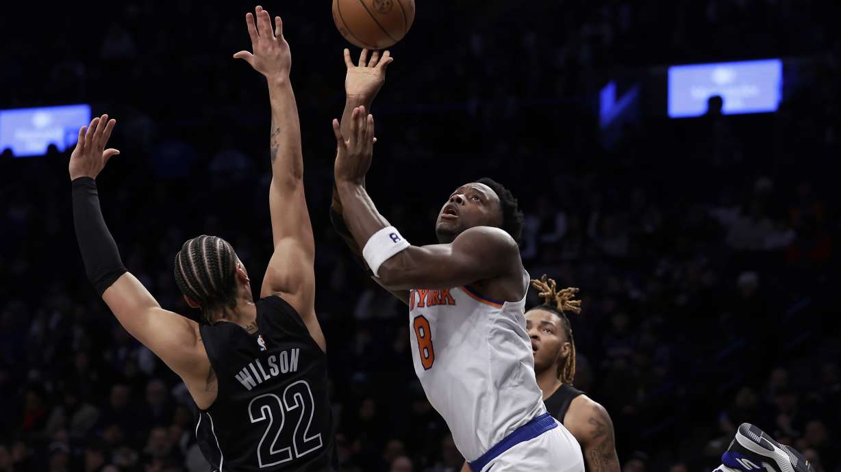 New York Knicks forward OG Anunoby (8) shoots over Brooklyn Nets forward Jalen Wilson during the first half of an NBA basketball game Tuesday, Jan. 21, 2025, in New York. The Knicks won 99-95.