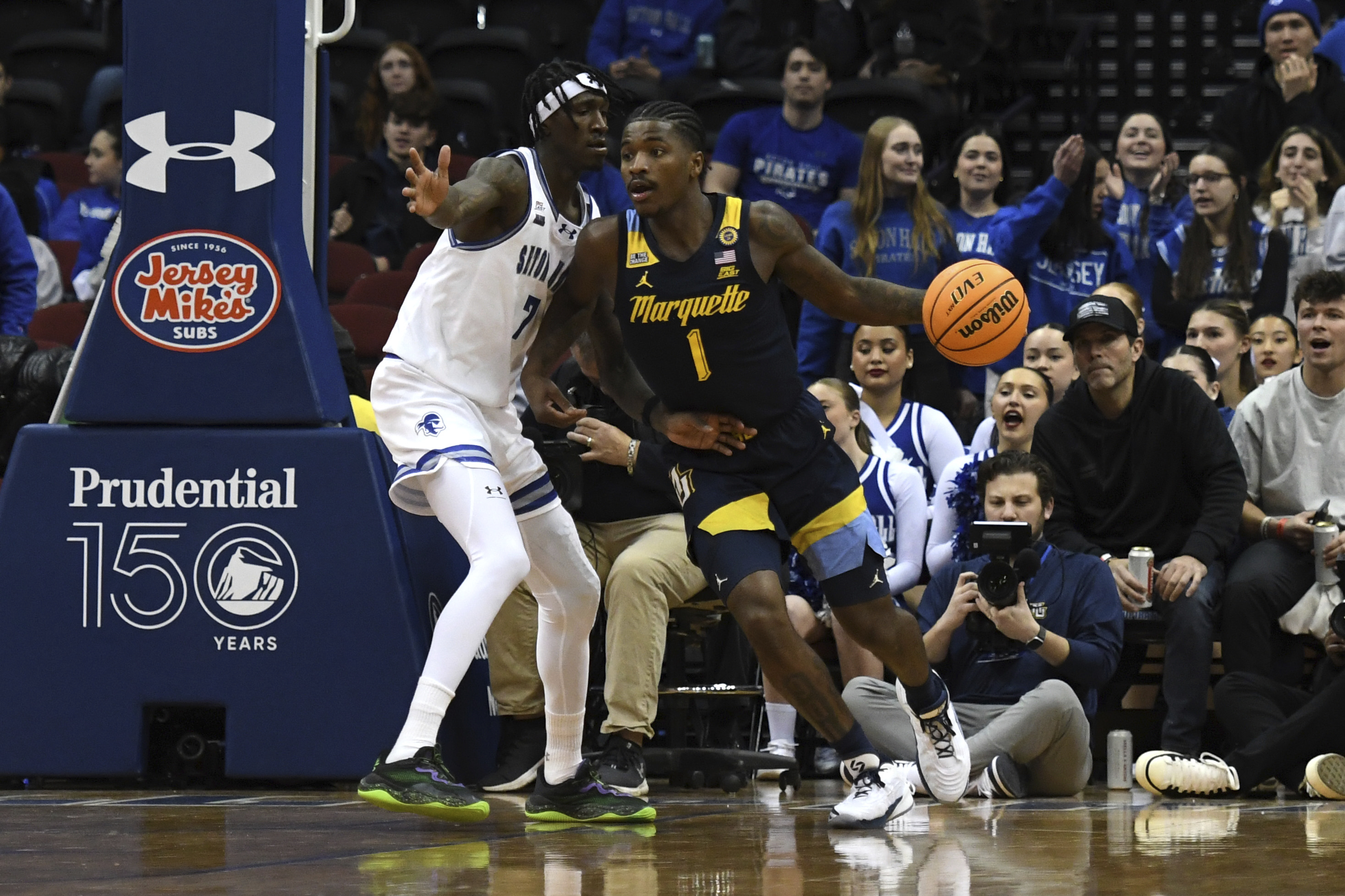 Marquette guard Kam Jones (1) dribbles the ball against Seton Hall forward Scotty Middleton (7) during the second half of an NCAA college basketball game Tuesday, Jan. 21, 2025, in Newark, N.J.