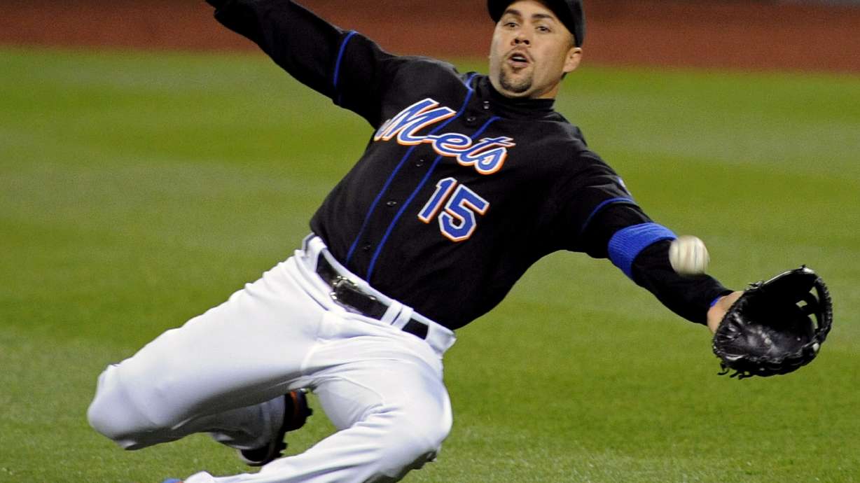 FILE - New York Mets right fielder Carlos Beltran lunges for the ball during the third inning of a baseball game against the Arizona Diamondbacks, April 22, 2011 at Citi Field in New York.