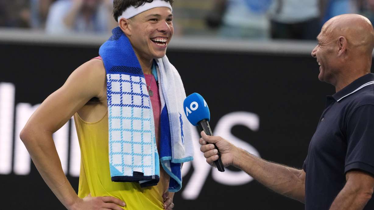Ben Shelton of the U.S. reacts as he is interviewed after Gael Monfils of France retired during their fourth round match at the Australian Open tennis championship in Melbourne, Australia, Monday, Jan. 20, 2025.