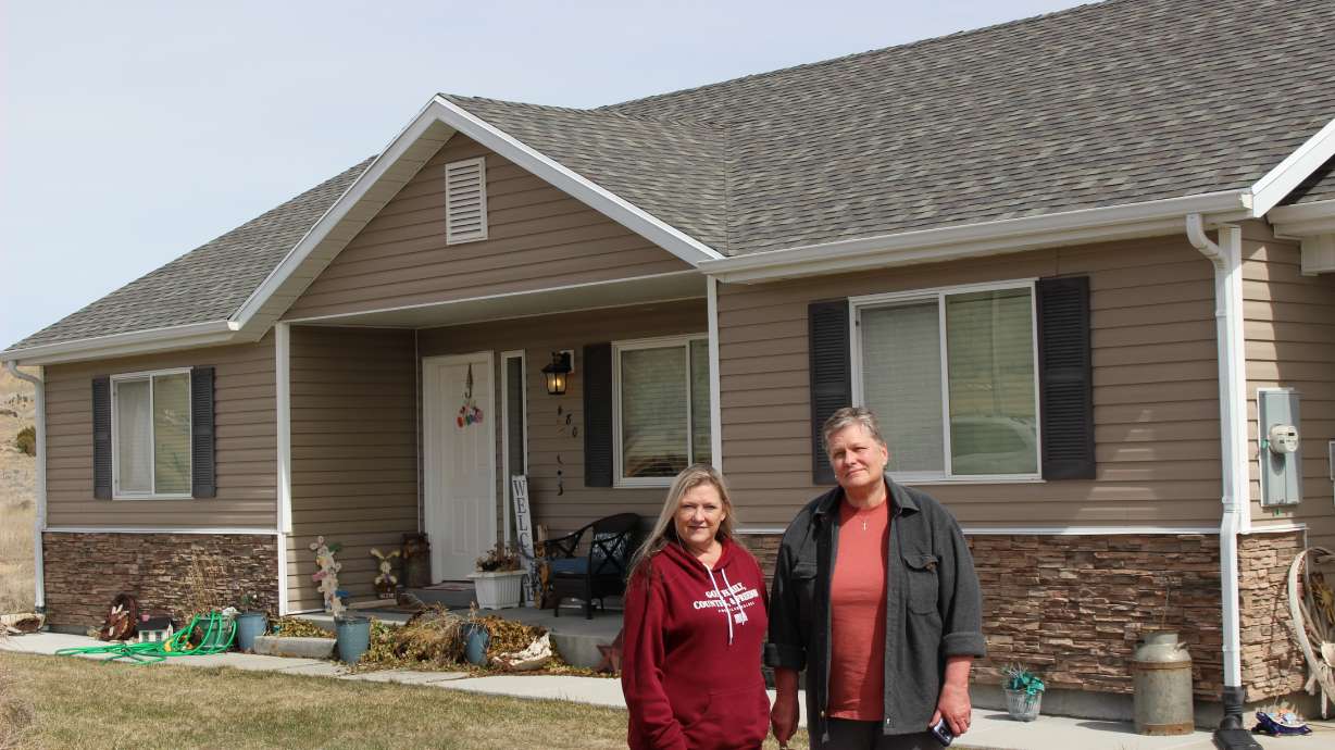 Tammy Bowman, left, and Beckie Gregg stand in front of Bowman's rented house in Tropic, Garfield County. Both are renting homes there but lost the ability to buy them or earn the equity they put into them.