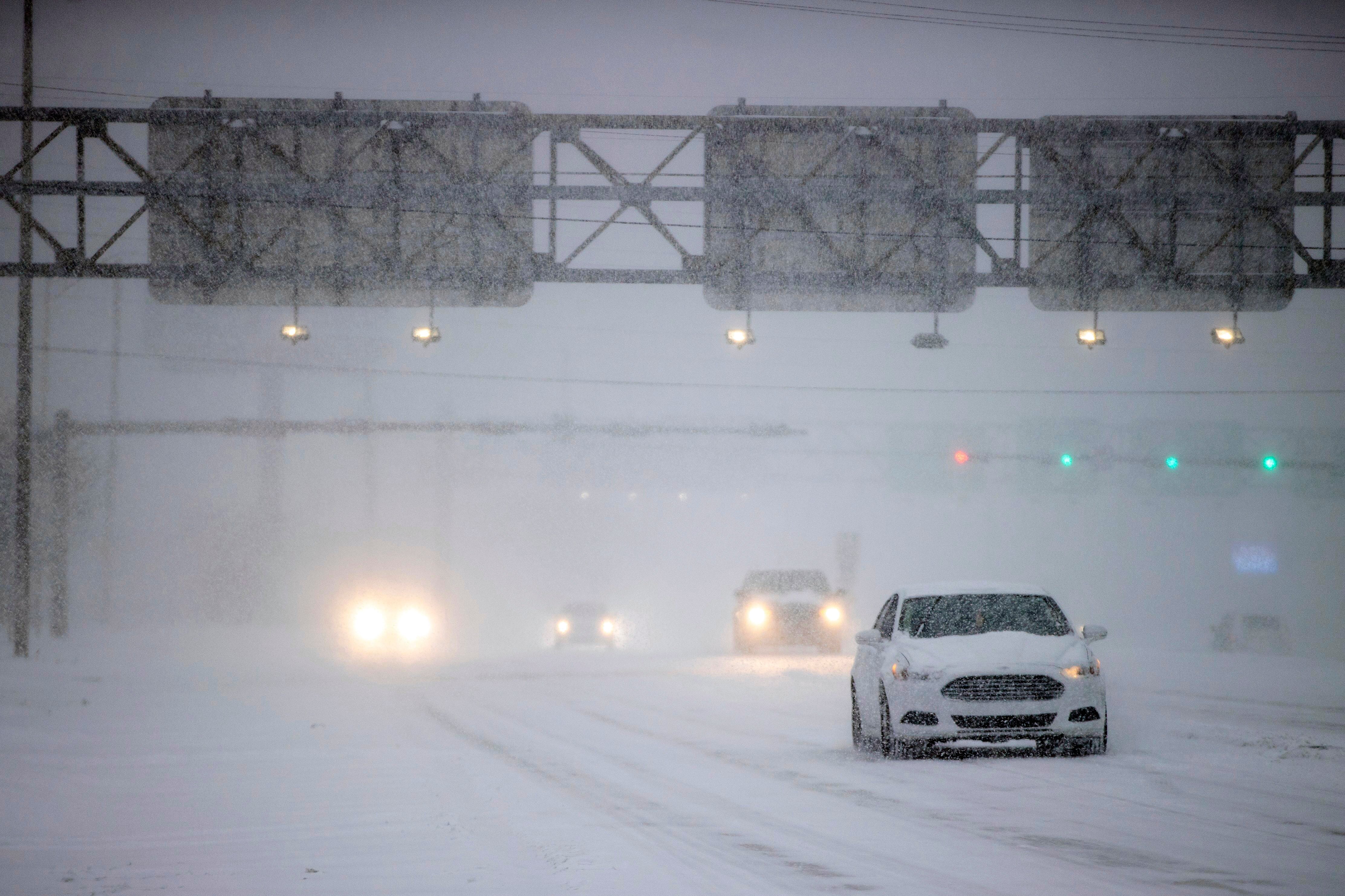 Motorists drive in heavy snow on N. Davis Highway on Tuesday, in Pensacola, Fla.