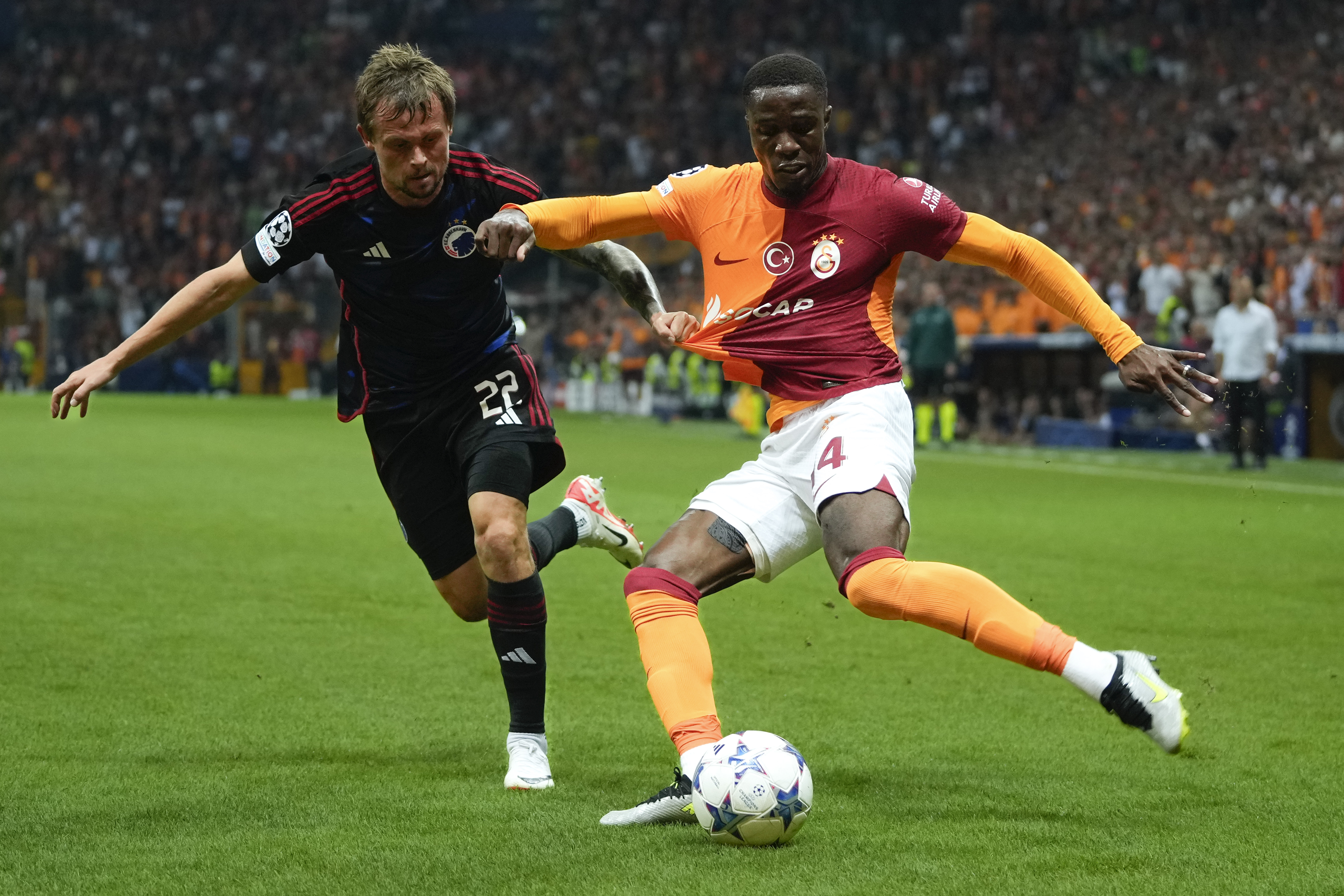 FILE - Copenhagen's Peter Ankersen pulls the shirt of Galatasaray's Wilfried Zaha, right, during their Champions League Group A soccer match between Galatasaray and FC Copenhagen in Istanbul, Turkey, Wednesday, Sept. 20, 2023.