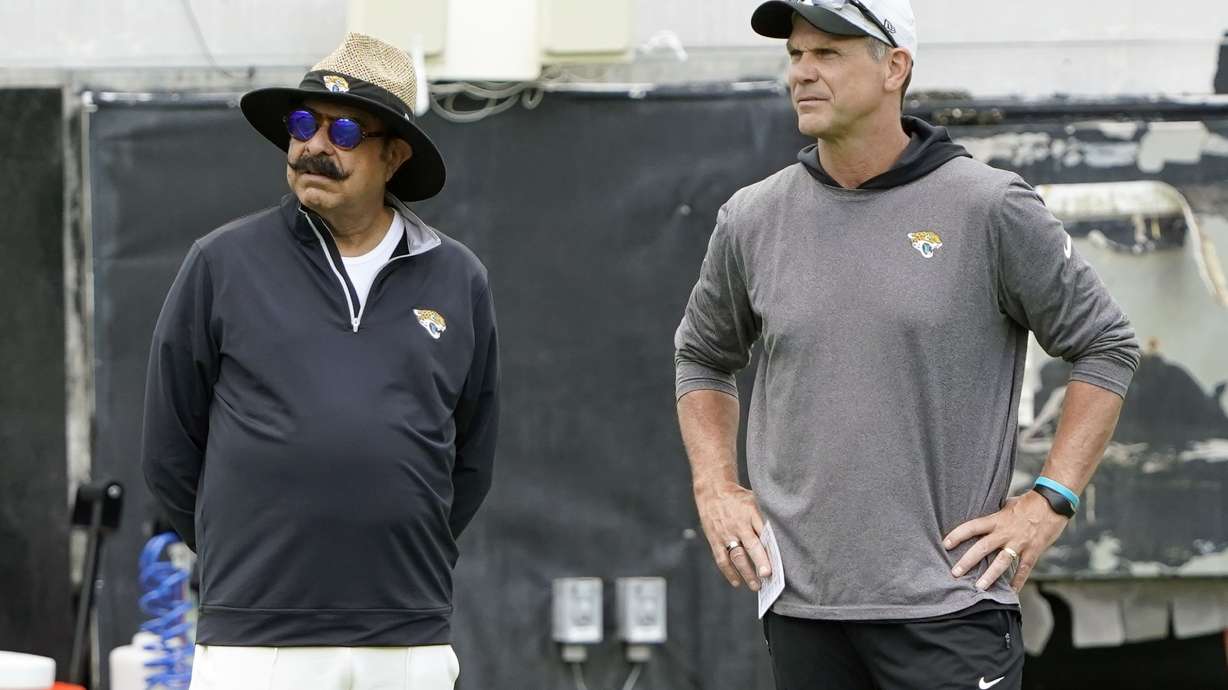 FILE - Jacksonville Jaguars owner Shad Khan, left, and general manager Trent Baalke watch players during the NFL football team's rookie minicamp, Saturday, May 14, 2022, in Jacksonville, Fla.