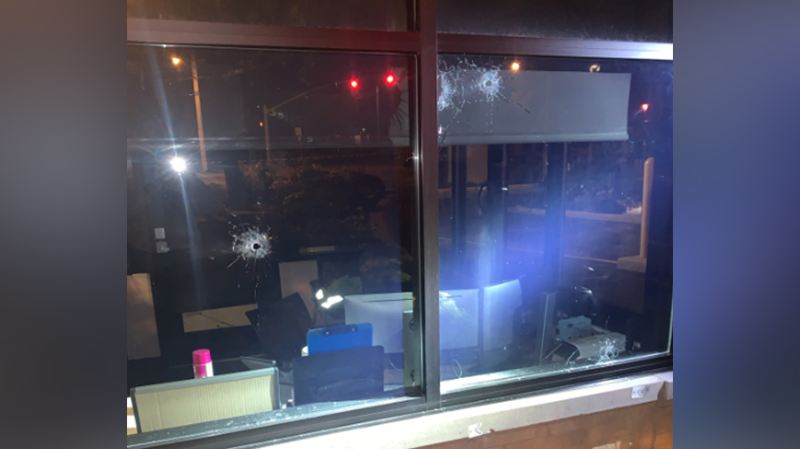 Bullet holes are seen in the window of a security booth at the Mission Training Center in Provo, following a shooting Aug. 3, 2020.