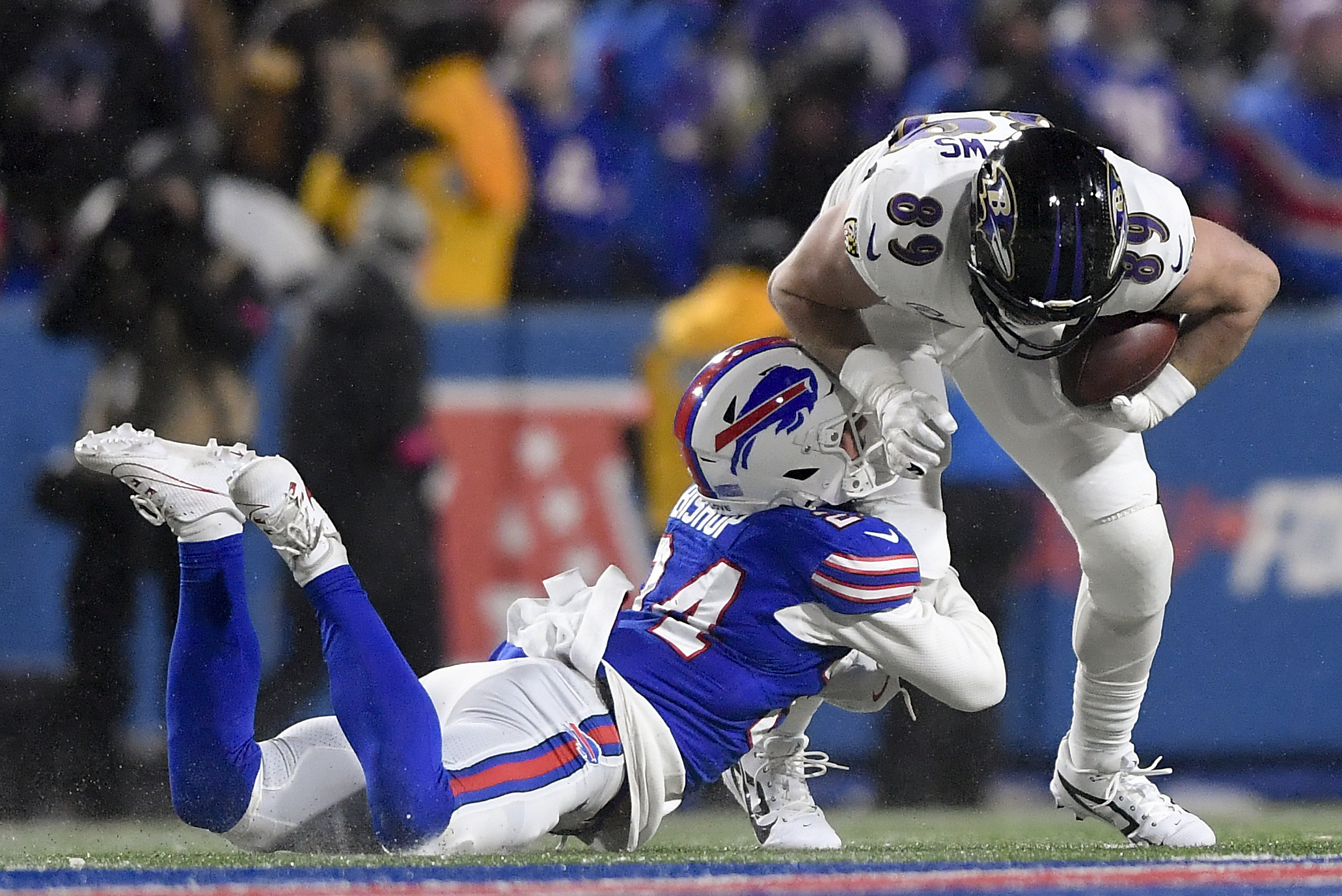 Buffalo Bills safety Cole Bishop (24) tackles Baltimore Ravens tight end Mark Andrews (89) during the third quarter of an NFL divisional playoff football game, Sunday, Jan. 19, 2025, in Orchard Park, N.Y.