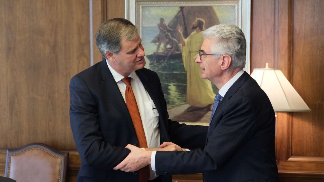 Presiding Bishop Gérald Caussé (right) thanks Adventist Development and Relief Agency President Michael Kruger for his organization's work helping those in need on Jan. 16 on the 26th floor of the Church Office Building in Salt Lake City.